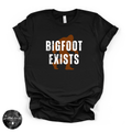 Bigfoot Exists Tee | Funny Cryptid Graphic T-Shirt (WHITE DESIGN)